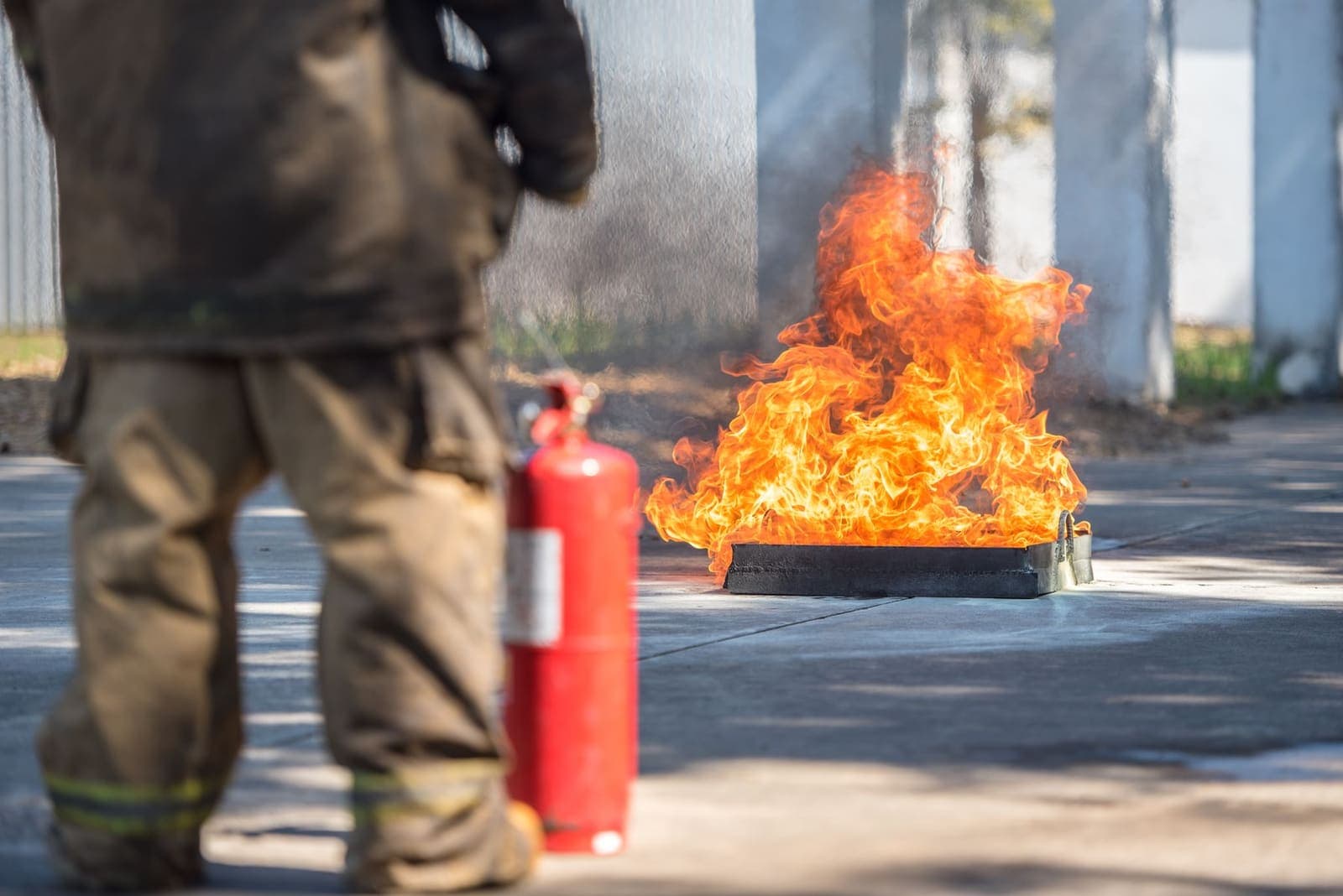 Fire safety training session with technicians demonstrating an extinguisher