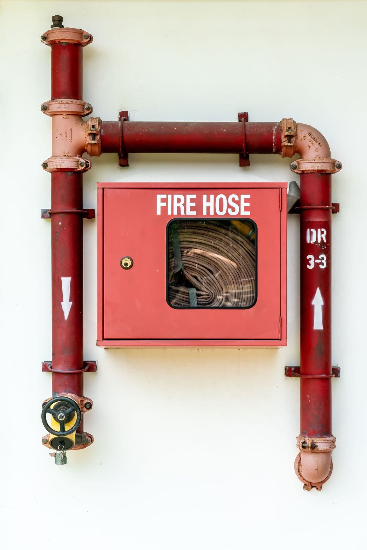 Wall-mounted fire hydrant standpipe with hose and valve